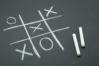 Tic tac toe game drawn on chalkboard