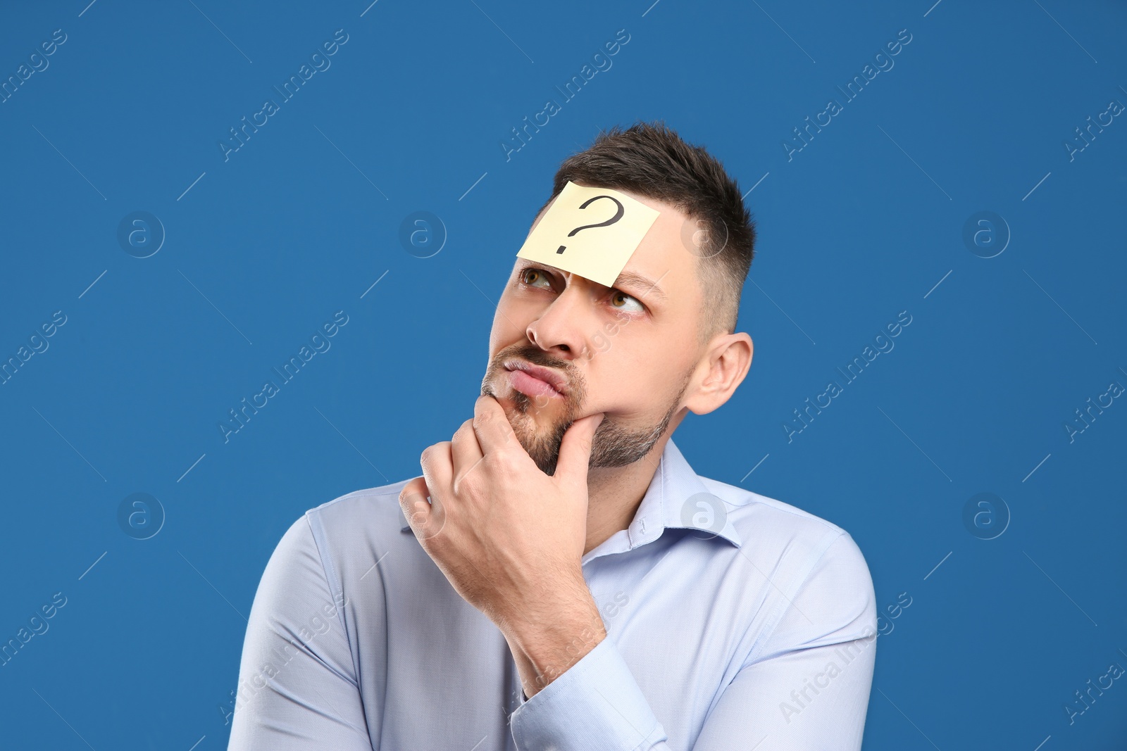 Photo of Emotional man with question mark on blue background