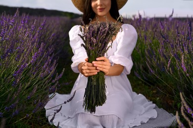 Photo of Woman with beautiful bouquet in lavender field, closeup