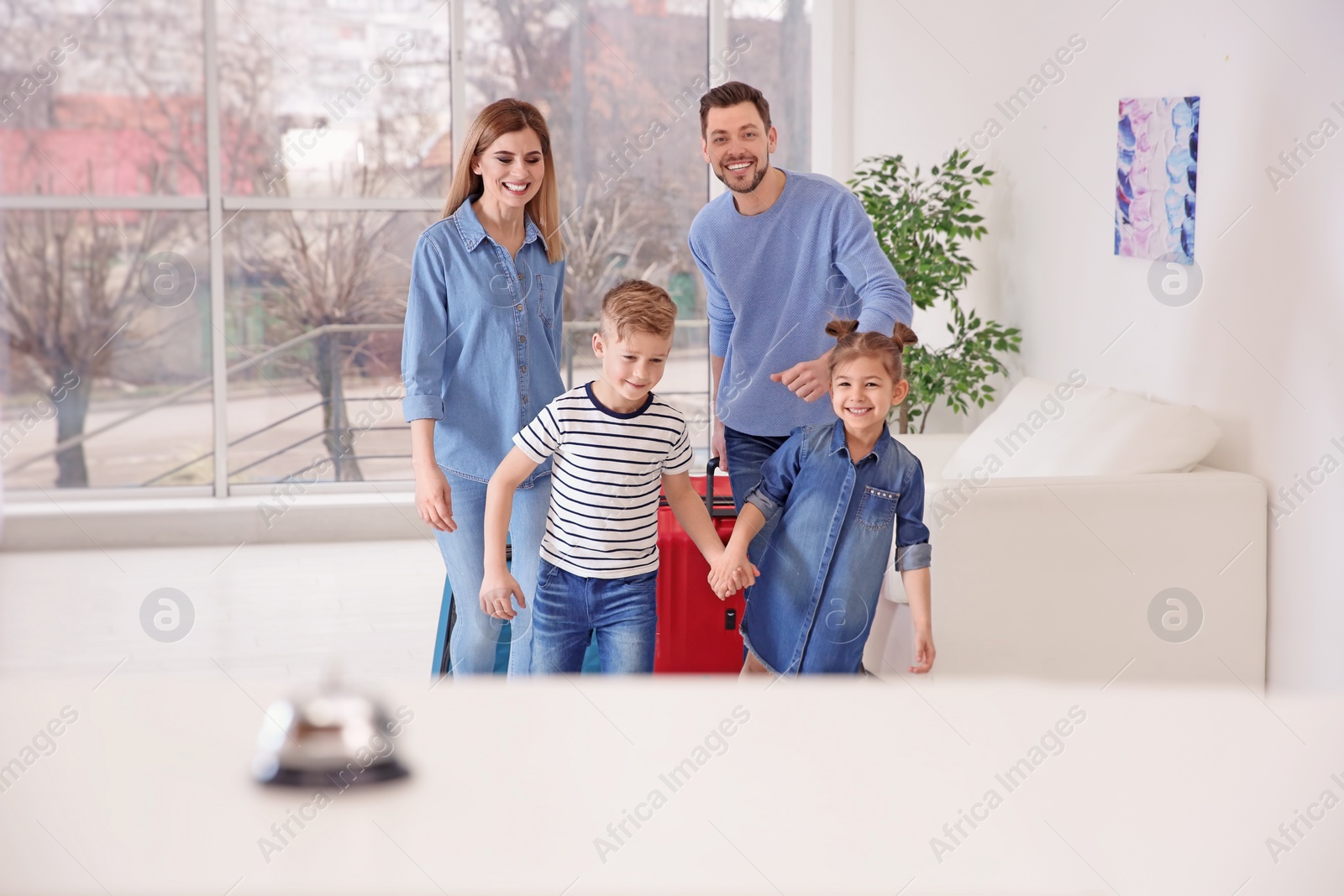 Photo of Happy family arriving in hotel