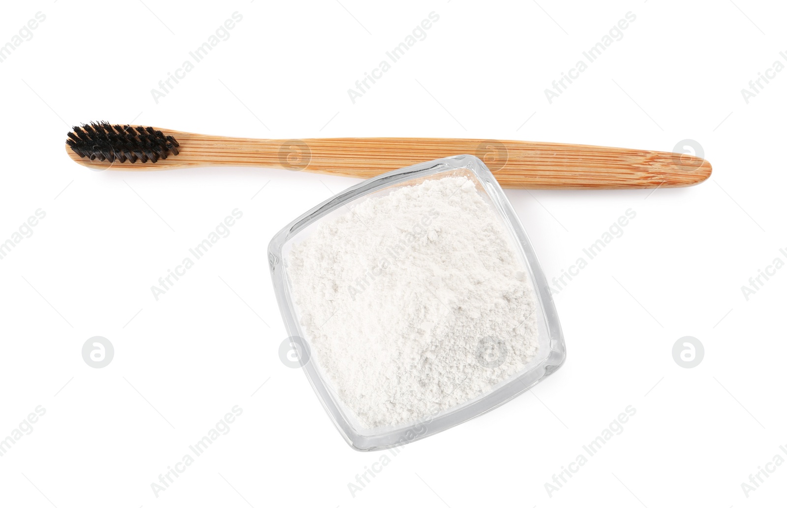 Photo of Bowl of tooth powder and brush on white background, top view