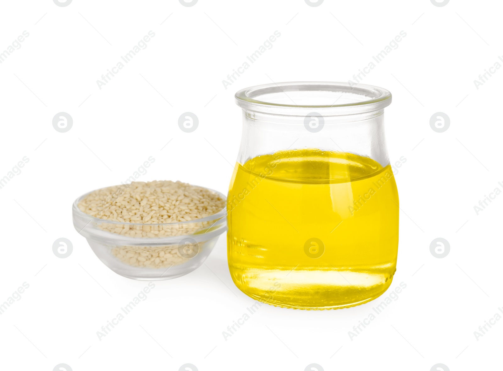 Photo of Glass jar of fresh sesame oil and bowl with seeds isolated on white