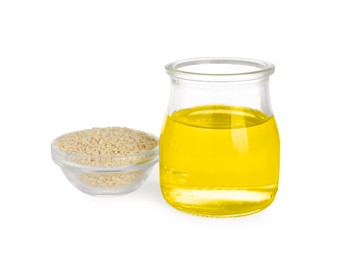 Photo of Glass jar of fresh sesame oil and bowl with seeds isolated on white