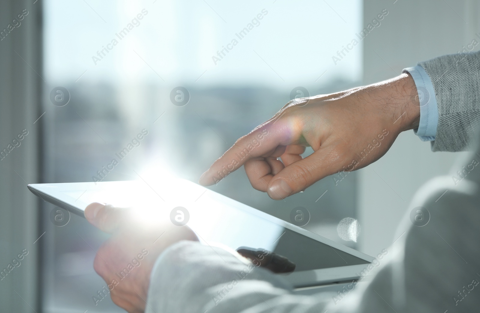 Photo of Closeup view of man using new tablet indoors