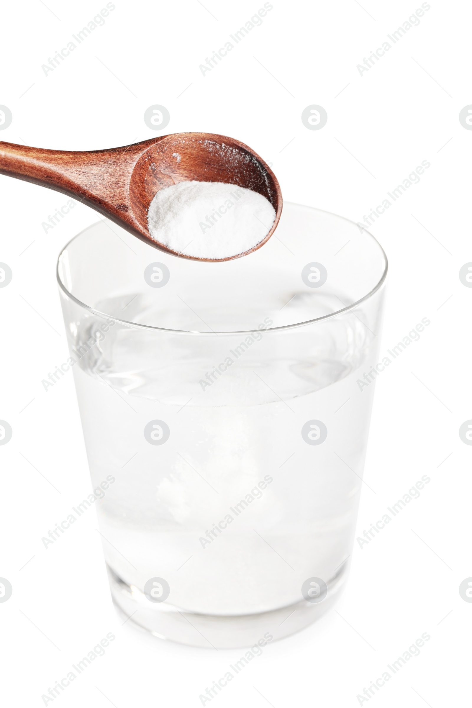 Photo of Adding baking soda into glass of water on light background