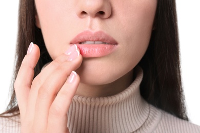 Young woman touching lips, closeup