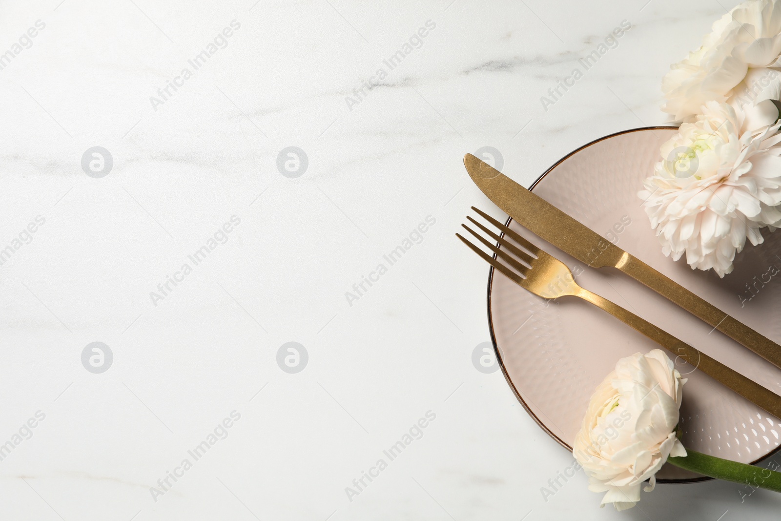 Photo of Stylish table setting with cutlery and flowers on white marble background, flat lay. Space for text