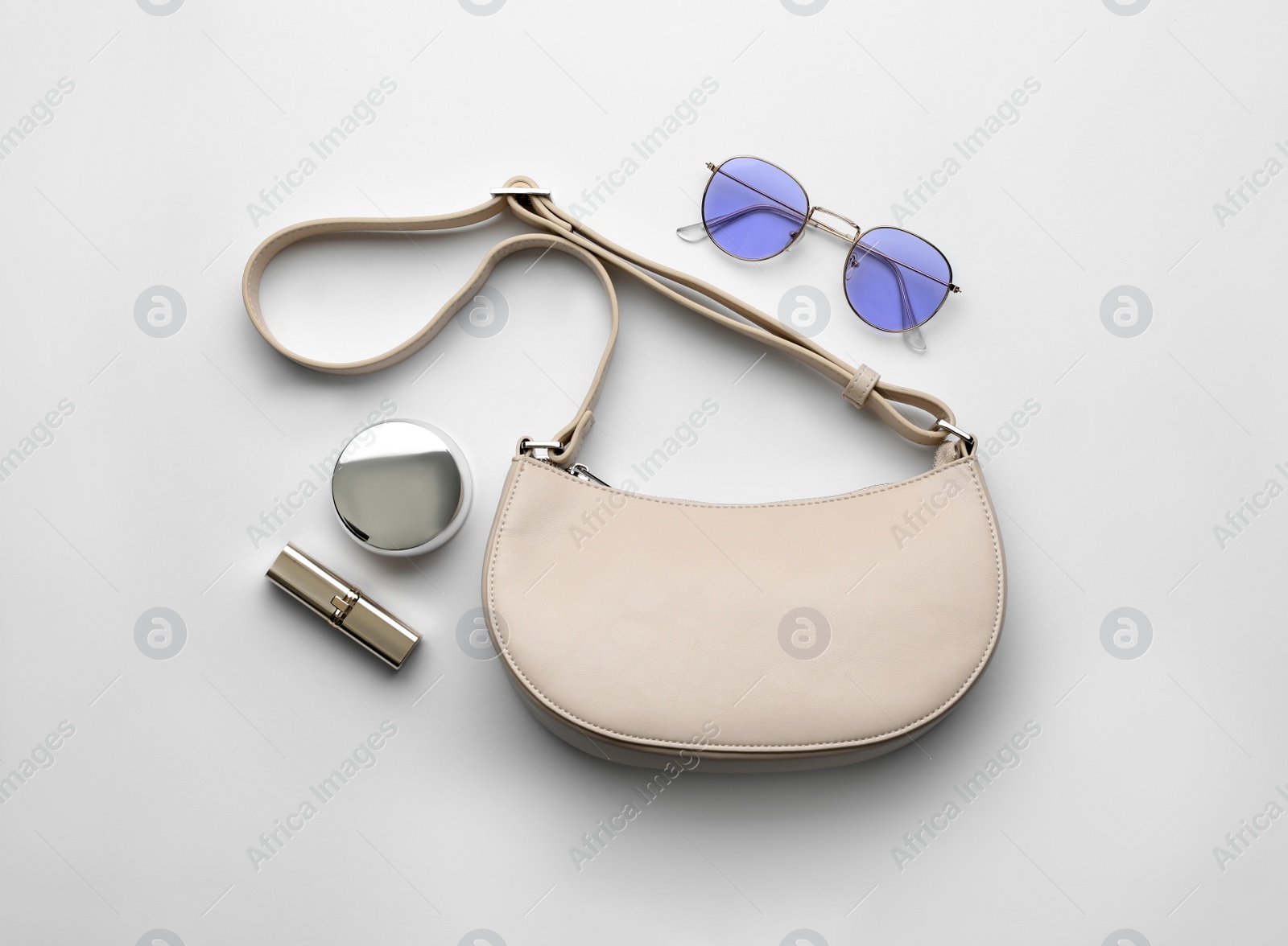 Photo of Flat lay composition with stylish woman's bag on light background