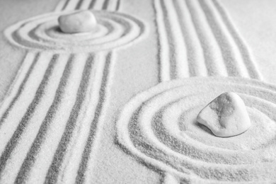 White stones on sand with pattern. Zen, meditation, harmony