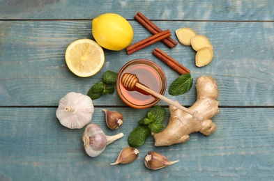 Flat lay composition with fresh products on light blue wooden table. Natural antibiotics