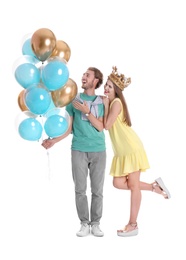 Photo of Young couple with air balloons on white background