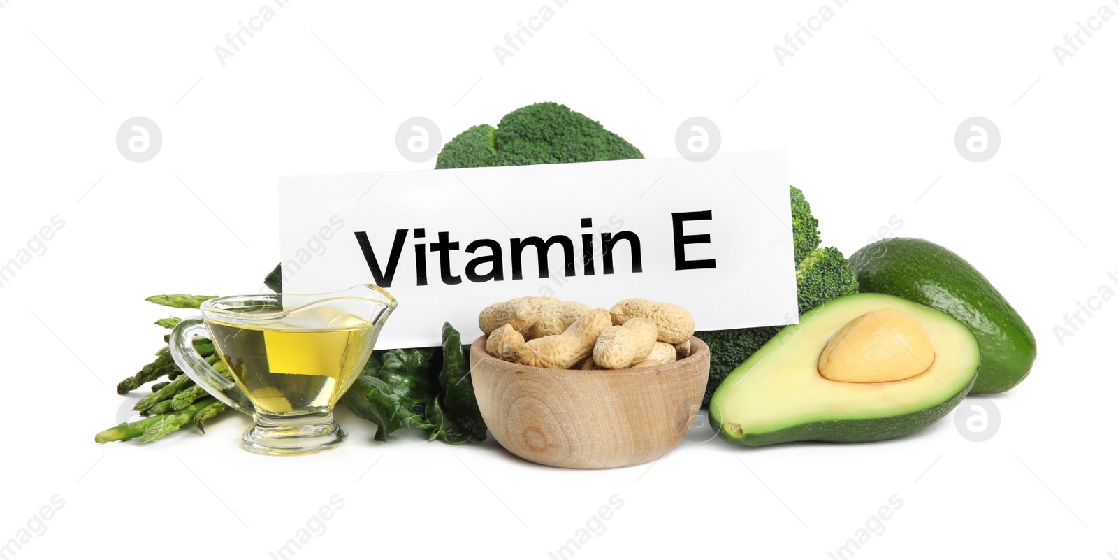 Photo of Card with phrase Vitamin E and different products on white background