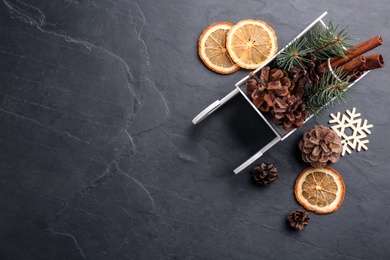 Photo of Beautiful Christmas composition with miniature sleigh on black slate table, flat lay. Space for text