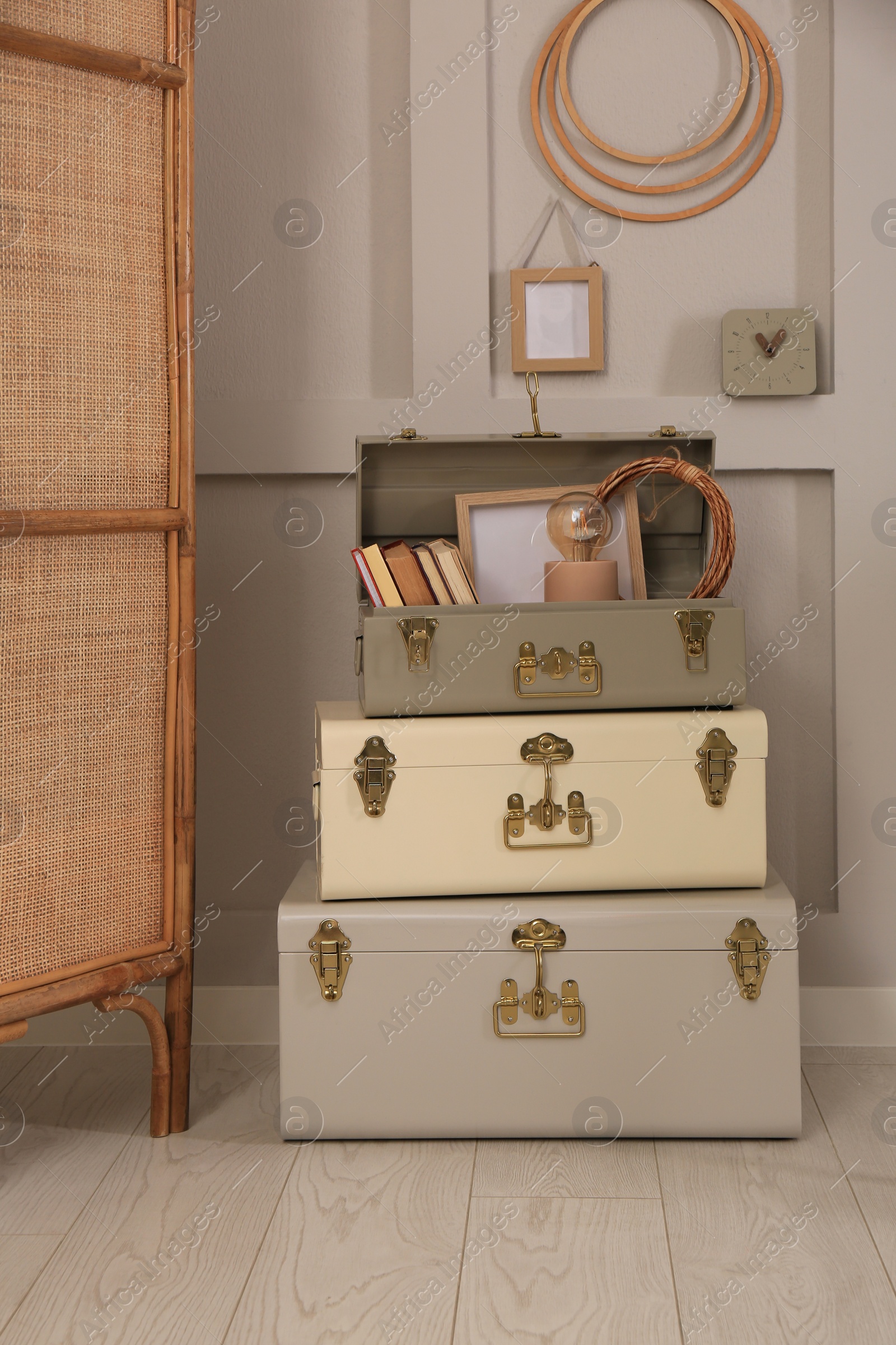 Photo of Storage trunks with different decor elements indoors. Interior design