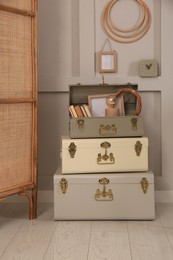 Storage trunks with different decor elements indoors. Interior design