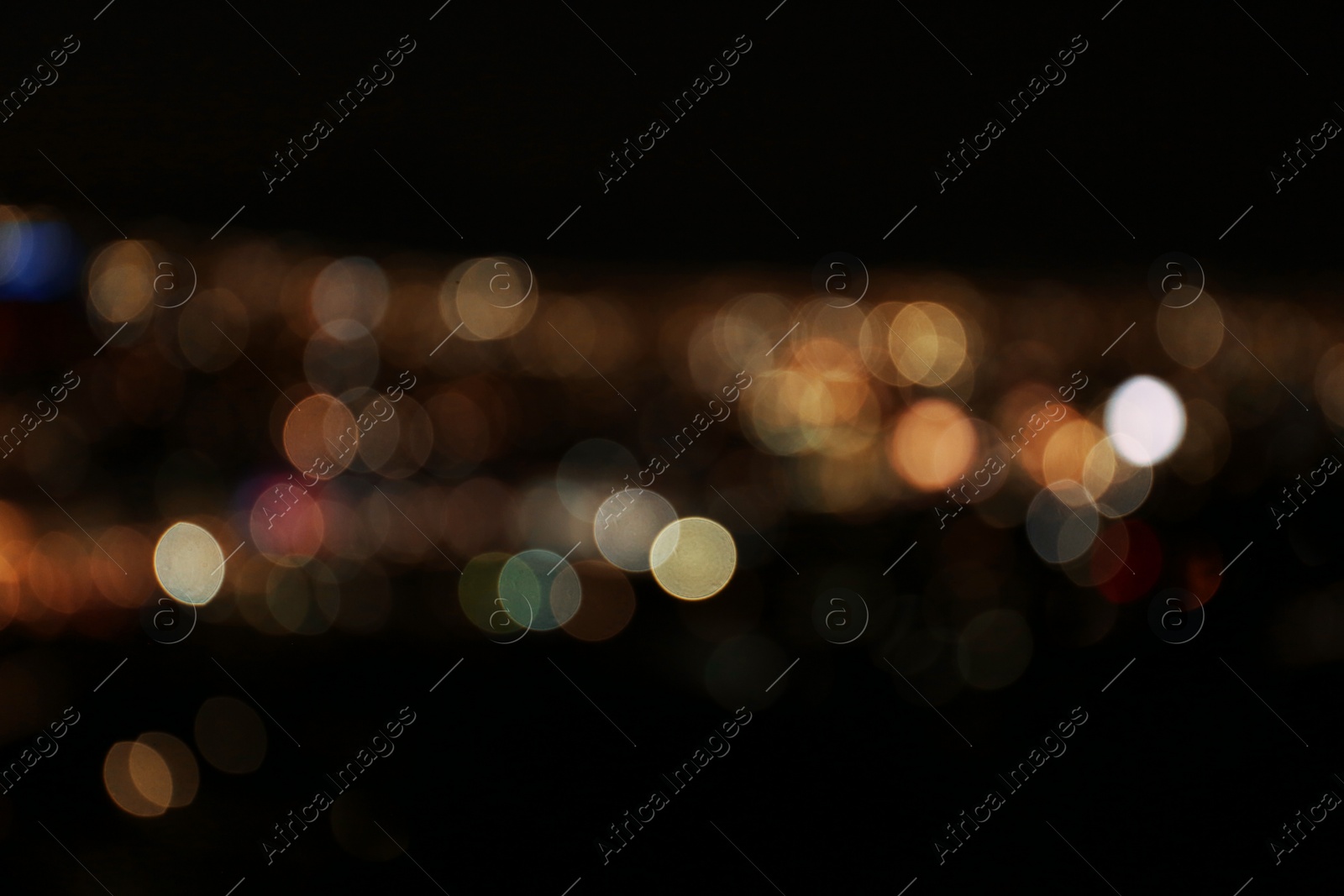 Photo of Blurred view of colorful glowing lights outdoors, bokeh effect