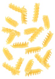 Raw fusilli pasta flying on white background