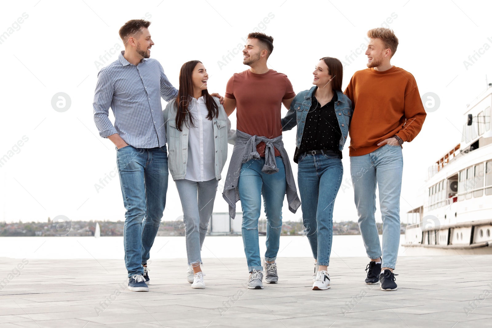 Photo of Group of happy people spending time together at promenade