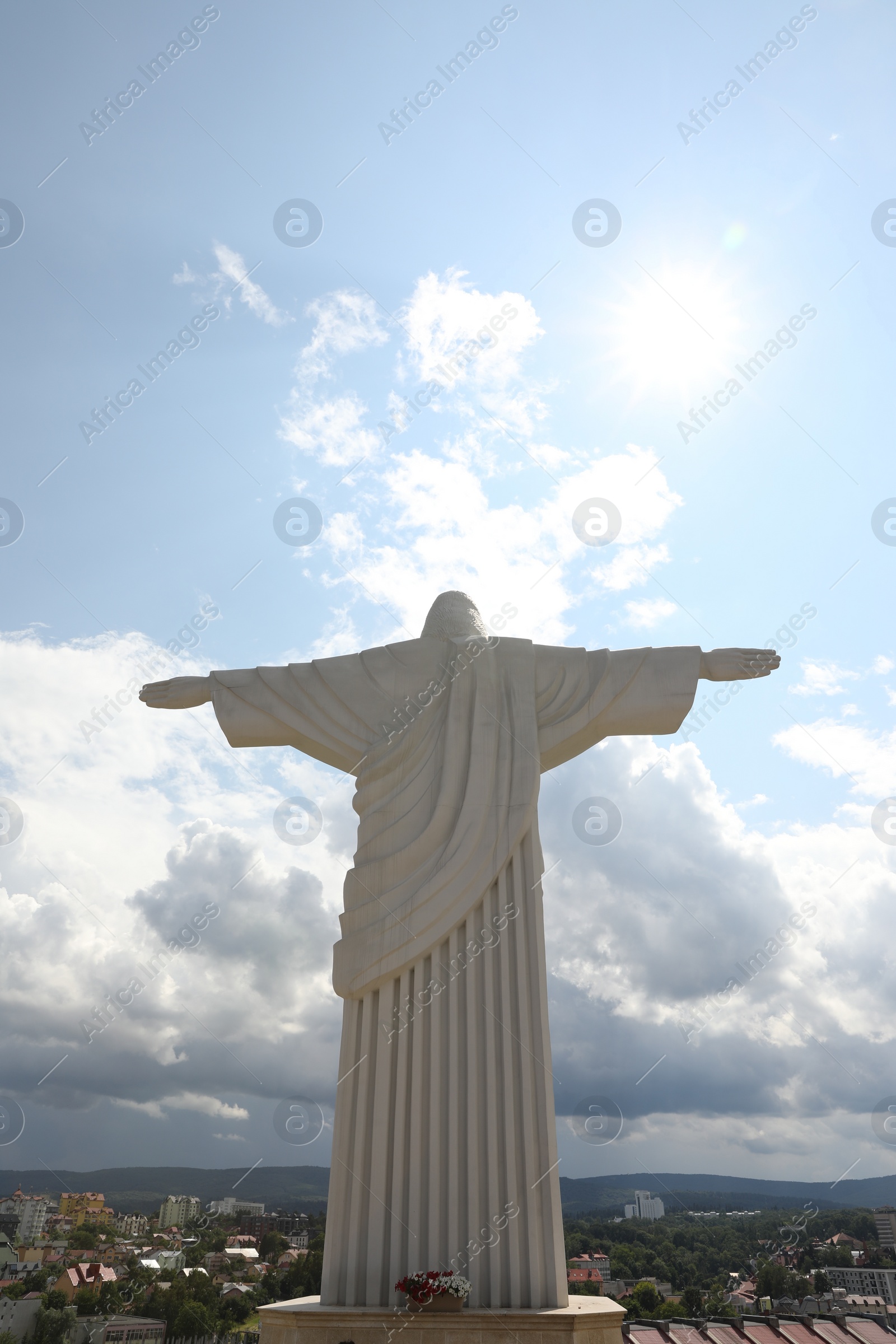 Photo of Truskavets, Ukraine - July 22, 2023: Statue of Christ the Redeemer against beautiful cityscape, space for text