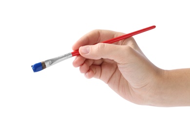 Photo of Young woman holding brush with color paint on white background, closeup