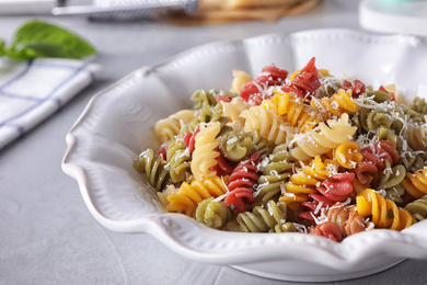 Photo of Delicious colorful pasta on light table, closeup