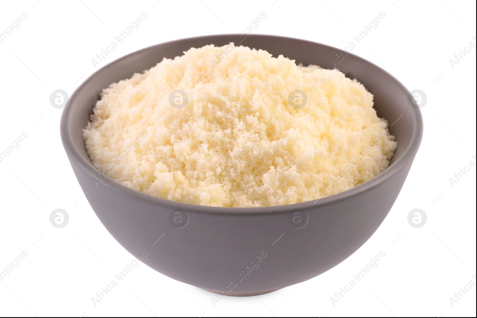 Photo of Delicious grated parmesan cheese in bowl isolated on white