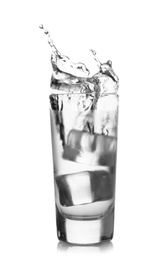 Photo of Ice cube falling into shot glass of vodka on white background