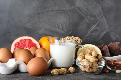 Photo of Different products on grey background. Food allergy concept