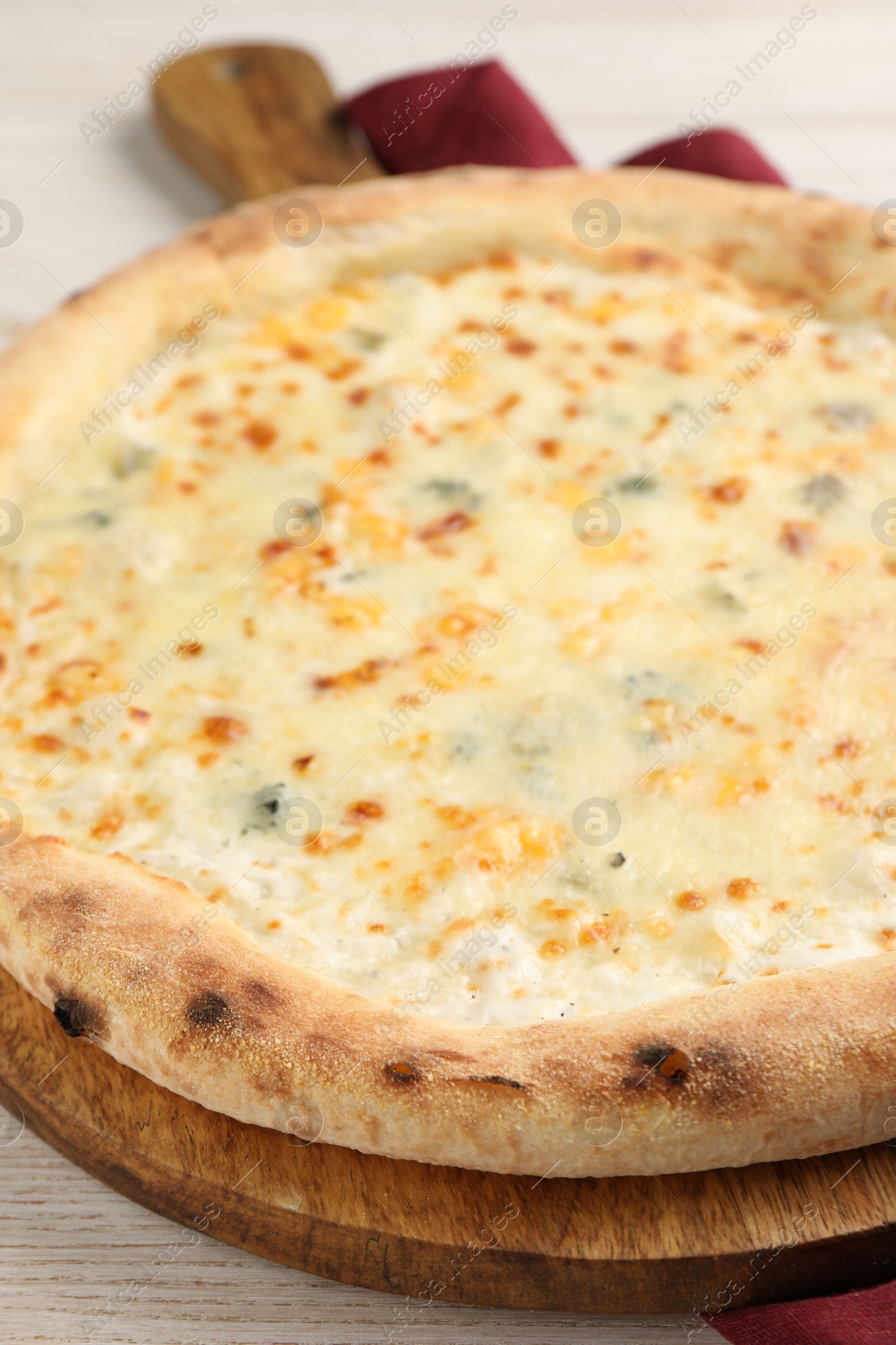 Photo of Delicious cheese pizza on white wooden table, closeup