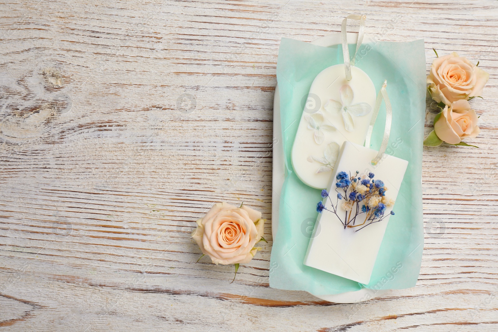 Photo of Flat lay composition with scented sachets on white wooden table, space for text