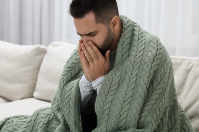 Photo of Sick man coughing at home. Cold symptoms