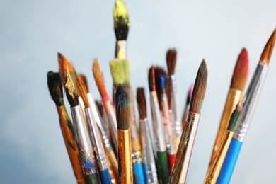 Photo of Different paint brushes on light background, closeup