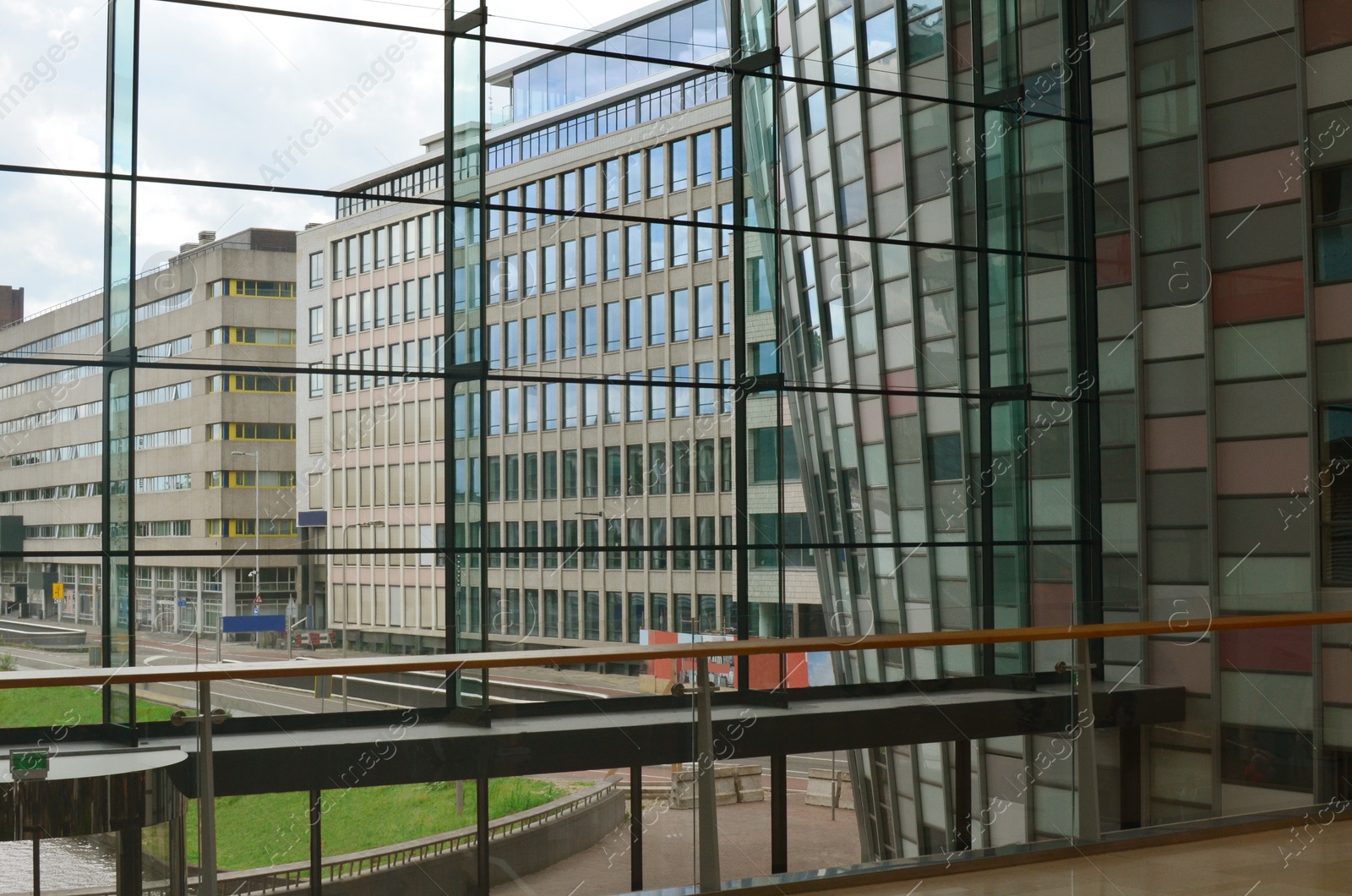 Photo of Beautiful city street with buildings, view through big glass windows