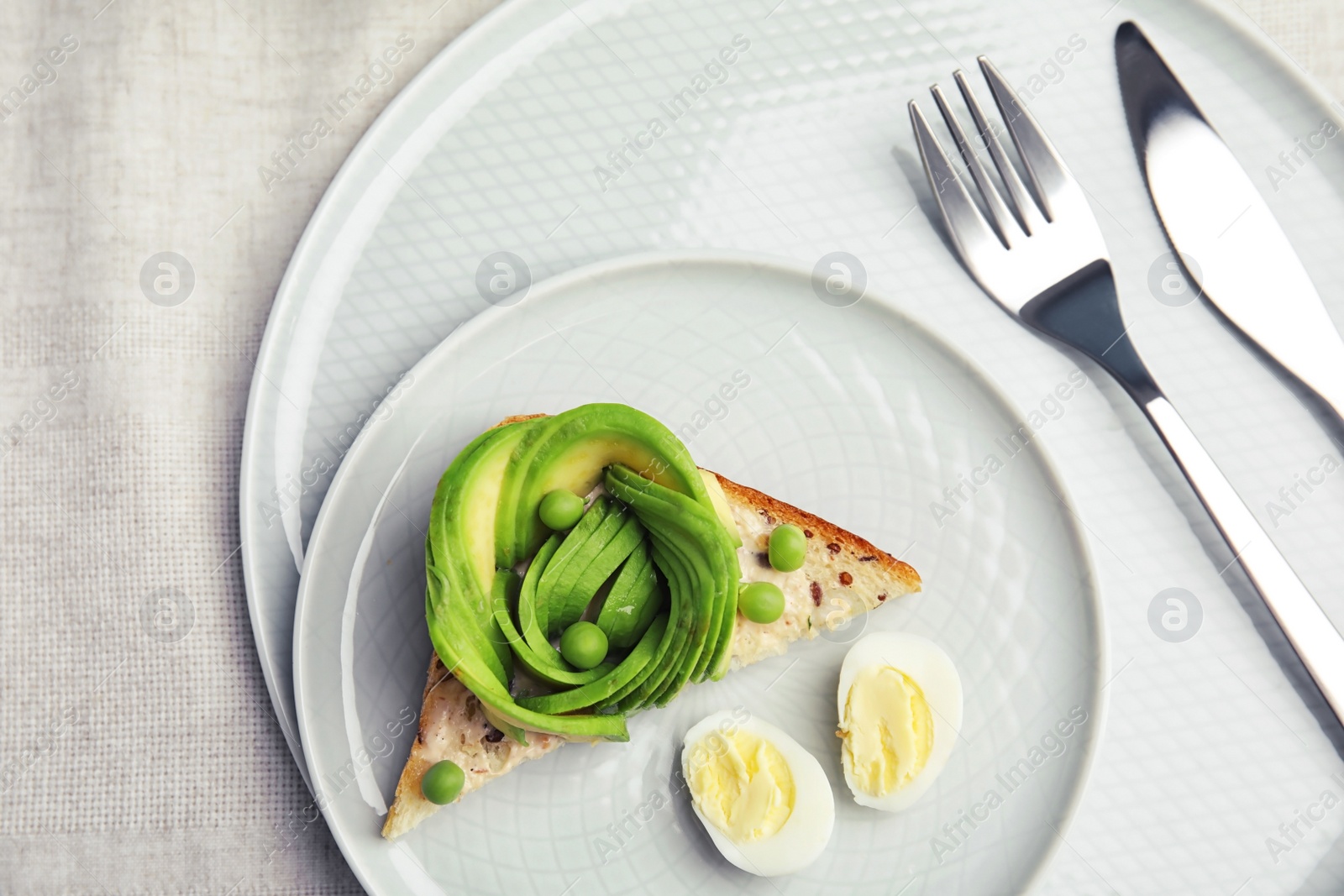 Photo of Tasty crisp toast with avocado on table, top view