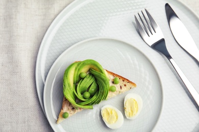 Tasty crisp toast with avocado on table, top view