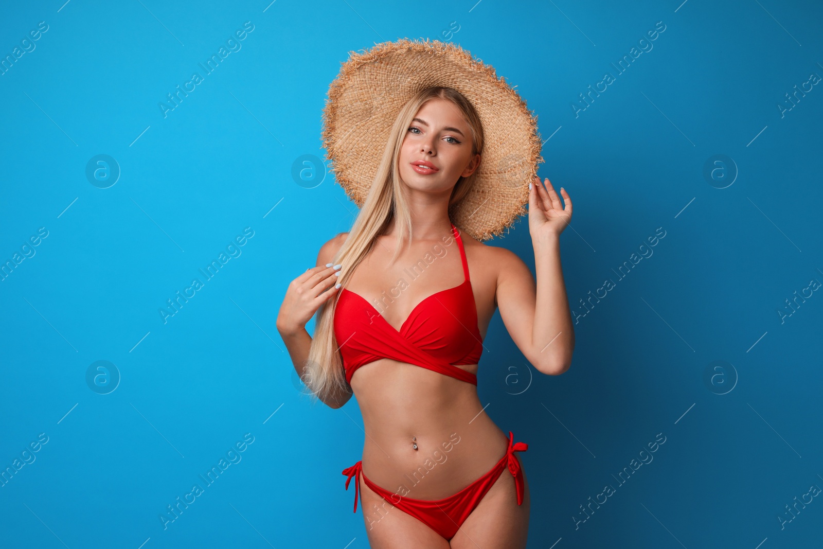 Photo of Pretty young woman wearing stylish bikini on blue background