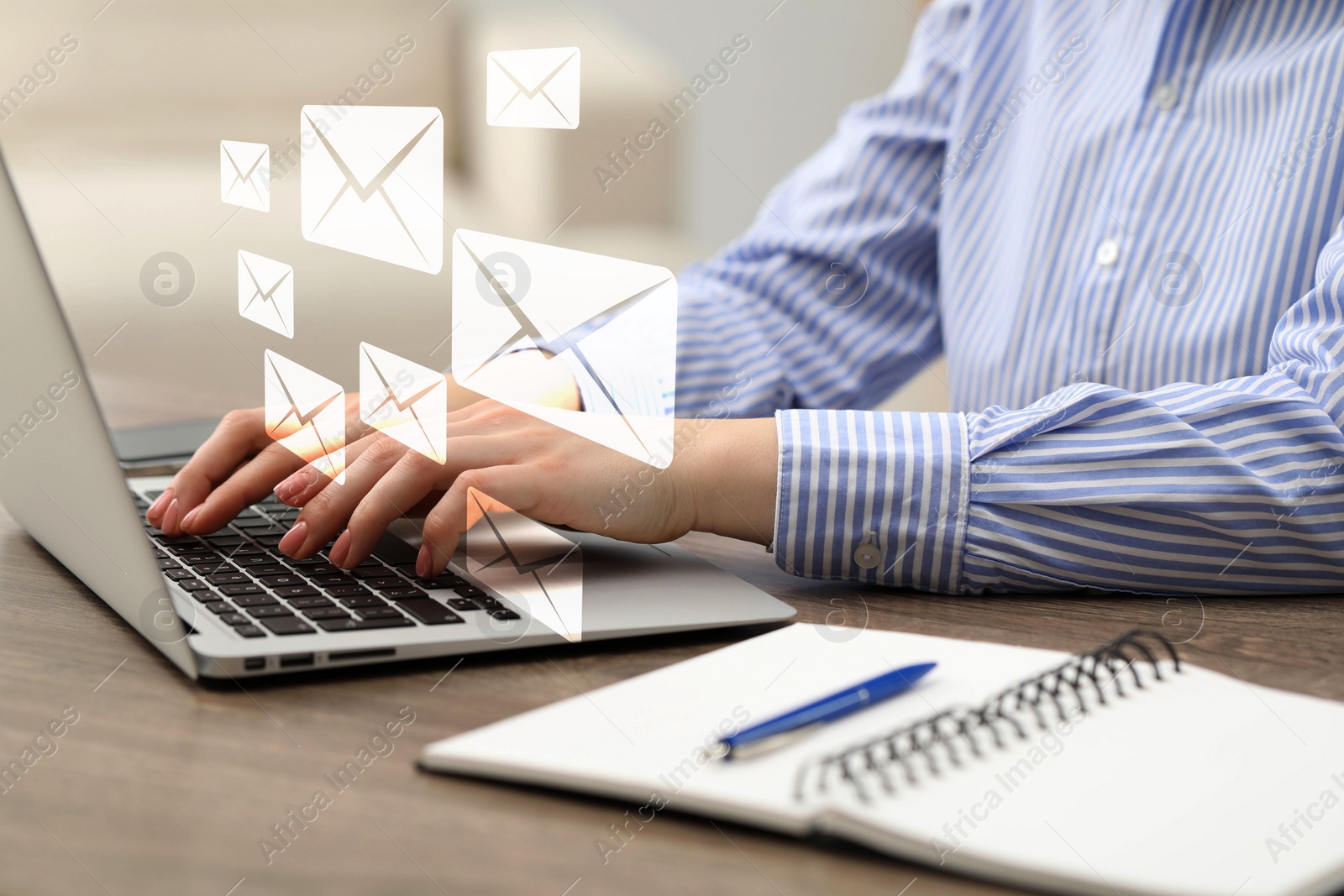 Image of Woman typing on laptop at table indoors, closeup. Many illustrations of envelope as incoming messages over device