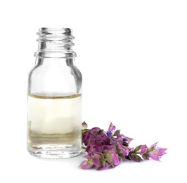 Photo of Bottle of herbal essential oil and sage flowers isolated on white