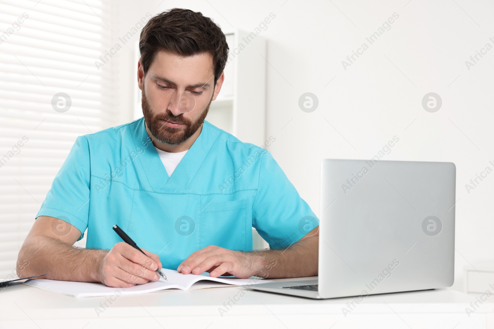 Photo of Doctor writing results from MRI scan in hospital