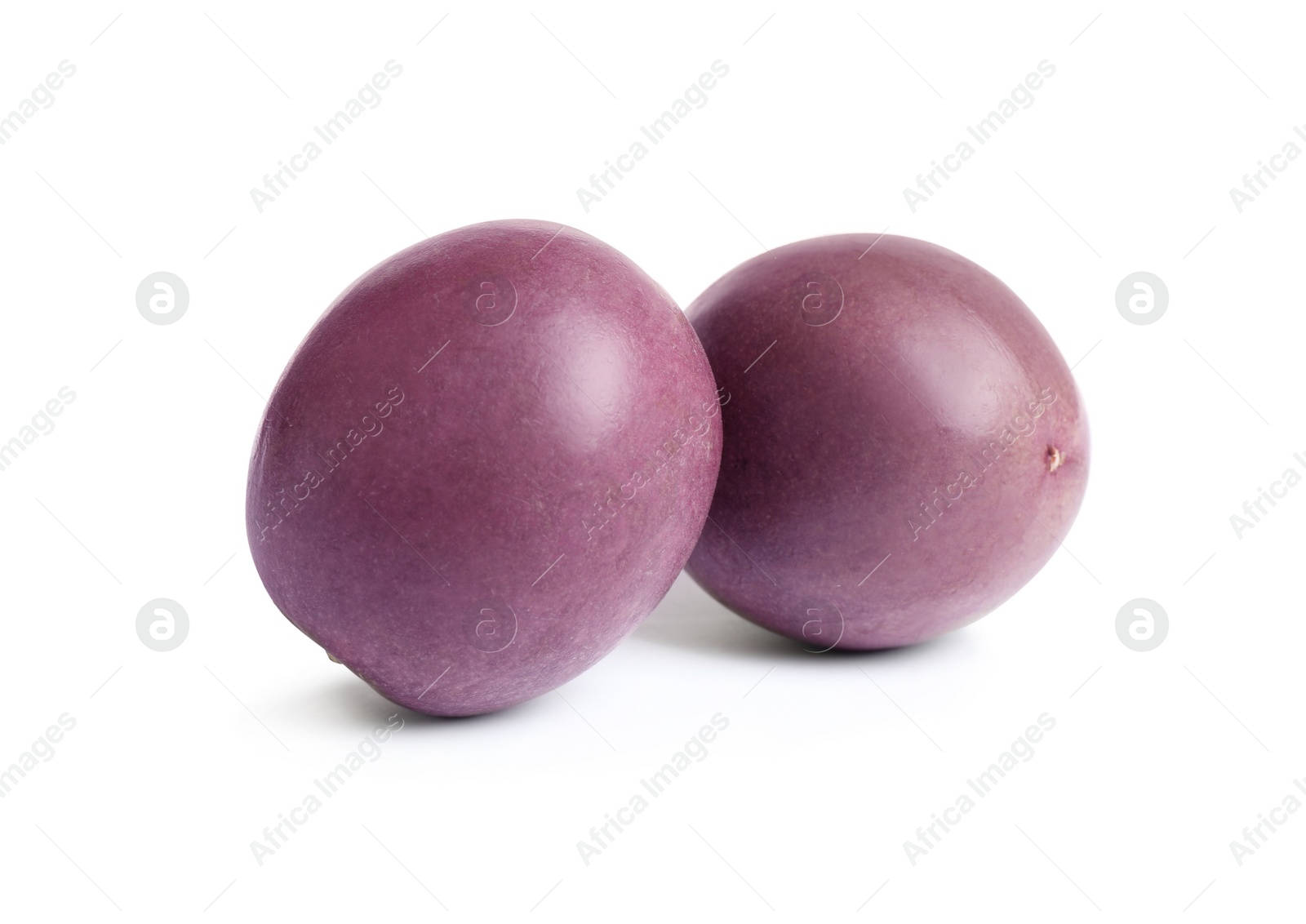 Photo of Delicious whole passion fruits (maracuya) on white background