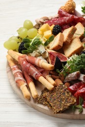 Photo of Different tasty appetizers on white wooden table, closeup