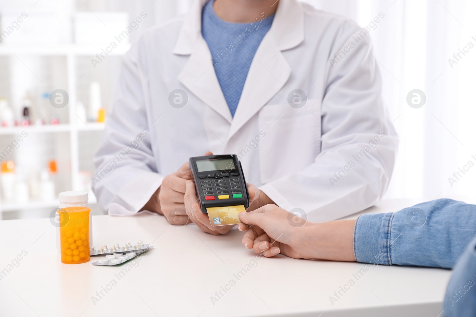 Photo of Client using credit card for terminal payment in pharmacy, closeup