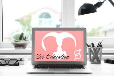 Image of Sex education. Modern laptop with open program on table near window