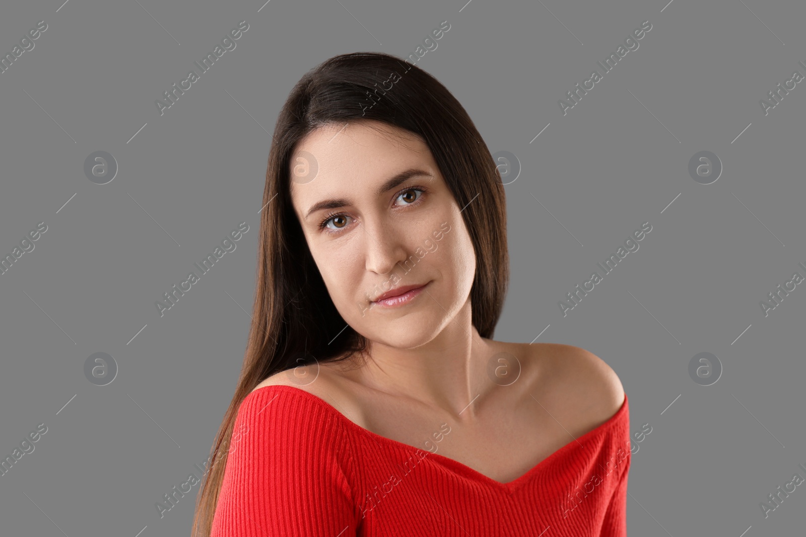 Photo of Portrait of beautiful young woman on grey background