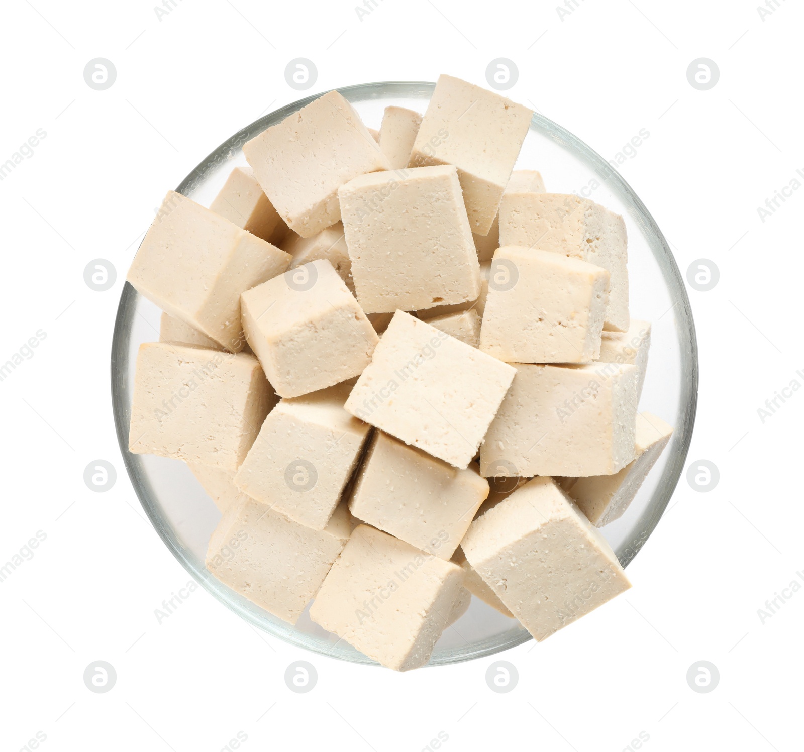 Photo of Glass bowl with delicious tofu isolated on white, top view