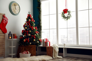 Photo of Stylish room interior with decorated Christmas tree