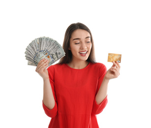 Young woman with money and credit card on white background