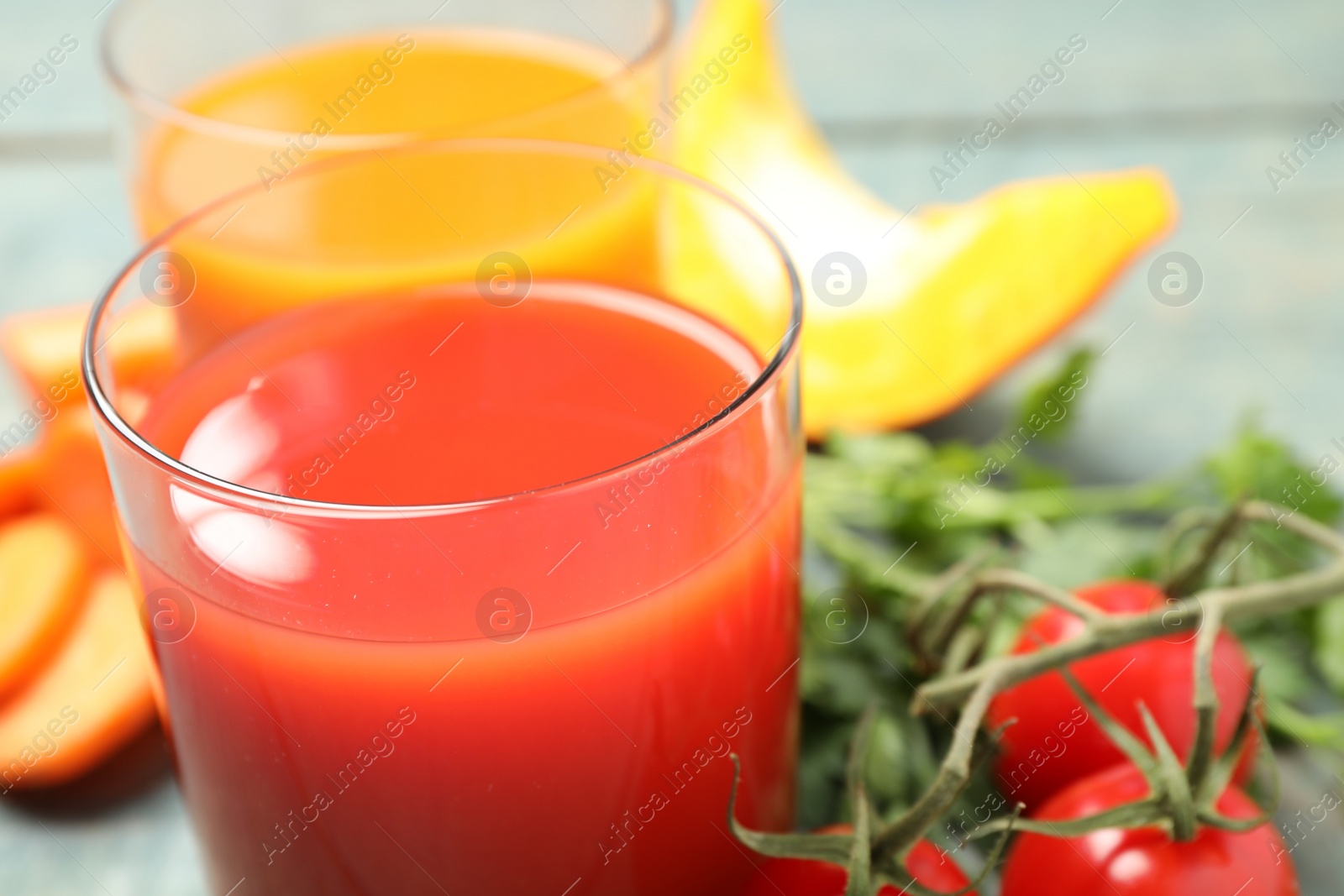 Photo of Delicious vegetable juice and fresh ingredients on table, closeup