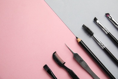 Photo of Set of professional eyebrow tools on color background, flat lay. Space for text