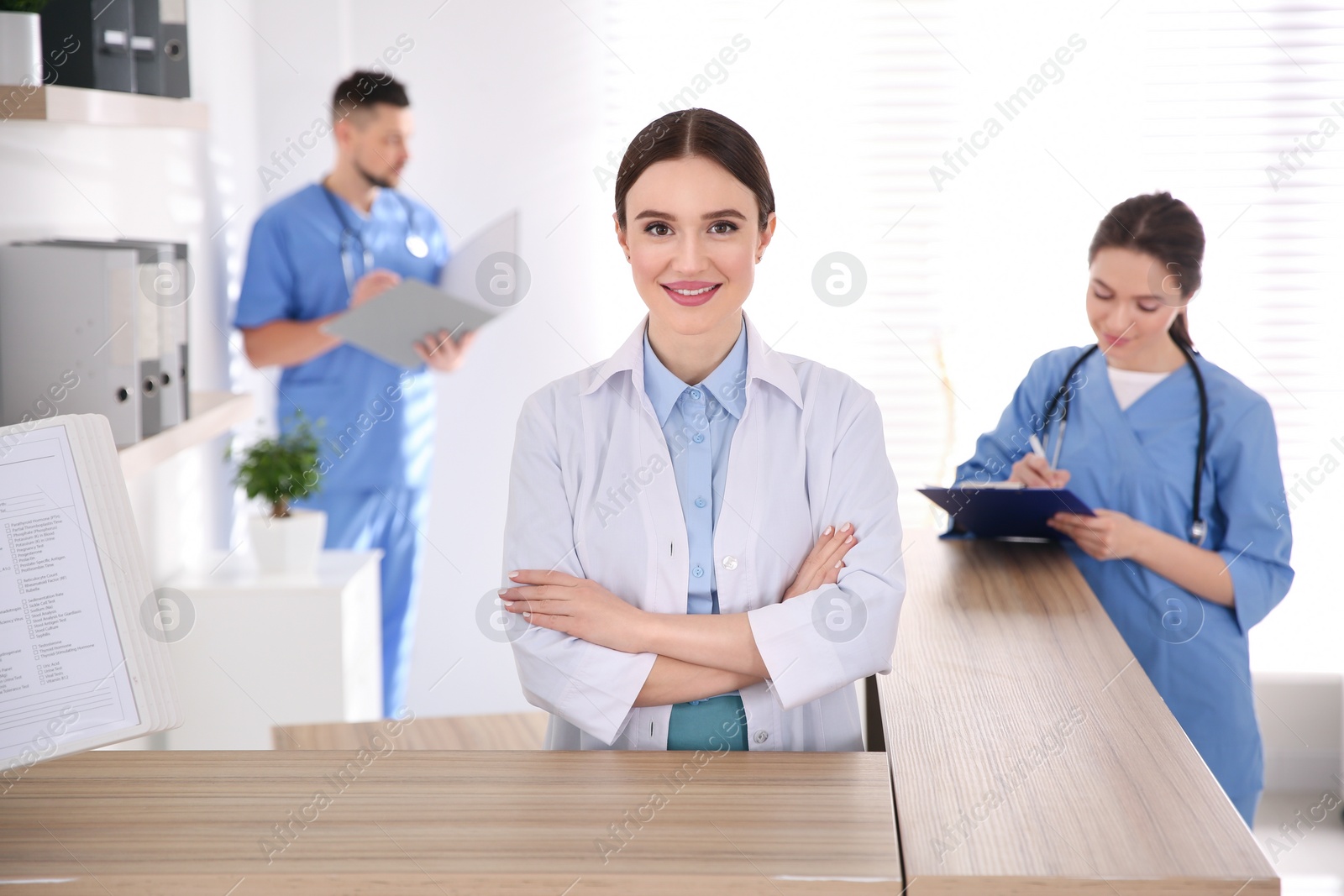 Photo of Portrait of female doctor at counter in modern clinic